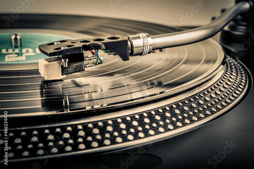 A needle on a turntable that plays music