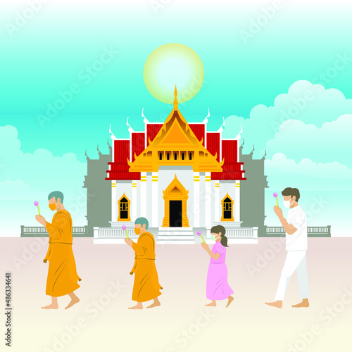 Monks and people are walk with lighted candles around a temple on religious days for Makha, Visakha, Asarnha Bucha, Visak and buddhist lent day in Covid-19 new normal Social distancing with face mask