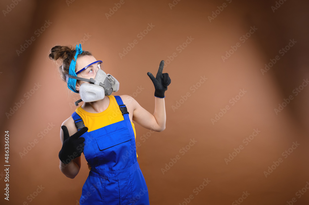 young caucasian woman in construction uniform stands on a colored background young caucasian woman in construction uniform stands on a colored background