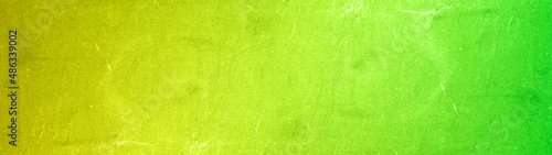 Abstract yellow neon green colored stone concrete cement scratched weathered ...