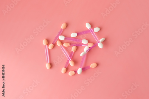 Sponges for applying makeup on a pink background. Empty space for the text.