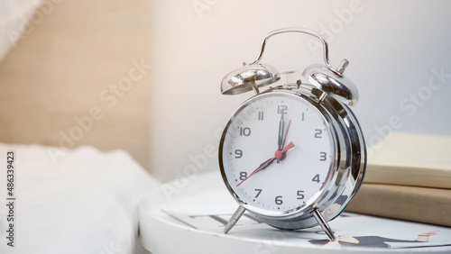 silver retro alarm clock showing eight am