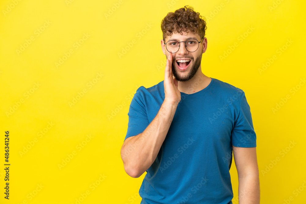 Young handsome caucasian man isolated on yellow background with surprise and shocked facial expression Young handsome caucasian man isolated on yellow background with surprise and shocked facial expression