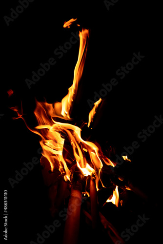 Beautiful formation of fire created by burning some dry reeds forming spectacular and bright flames in the dark of the night. Concept of beauty and destruction.