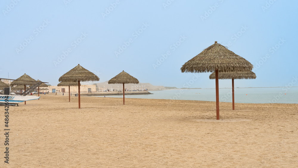 Fototapeta premium Family beach in the Wakrah souq (Traditional Market) along with traditional boats