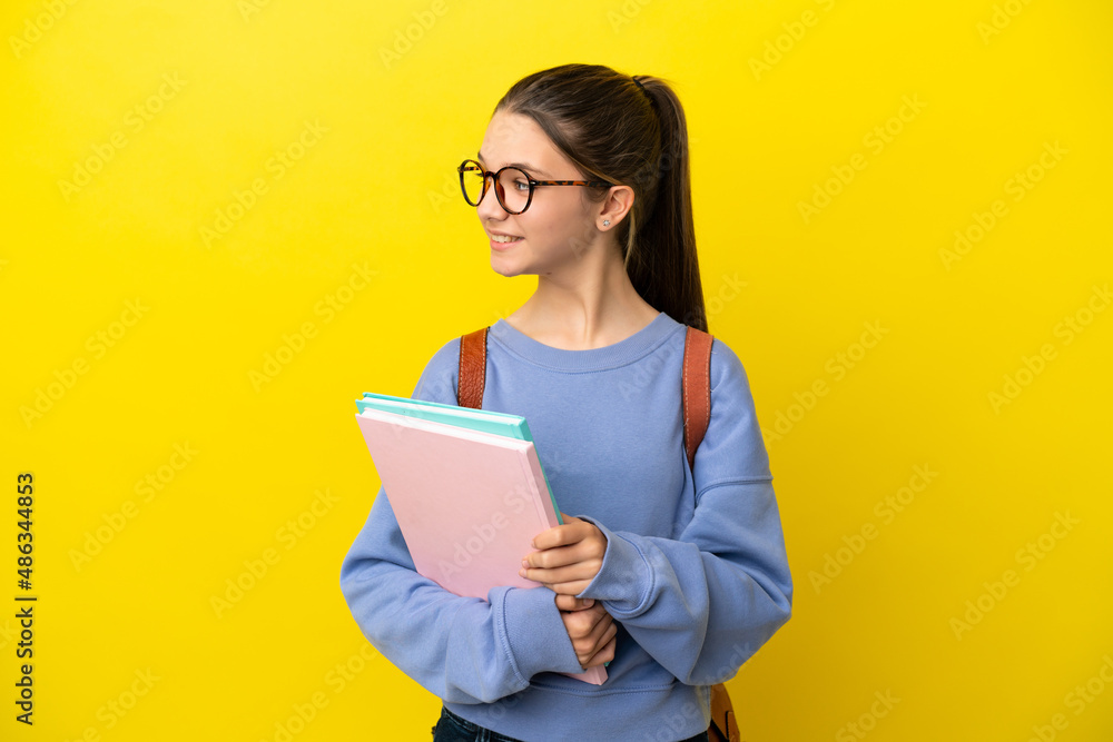 Student kid woman over isolated yellow background looking side Student kid woman over isolated yellow background looking side