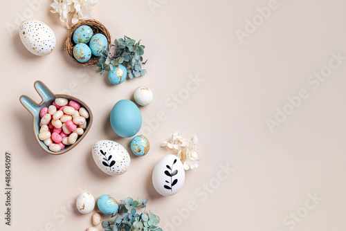 Wallpaper Mural Easter eggs with candy and flowers on beige. Happy Easter concept. White and blue eggs with cute plate in the shape of a bunny Torontodigital.ca