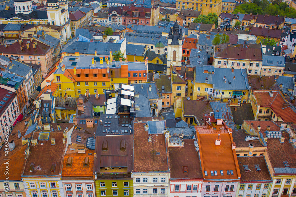Rows of colorful and funny small houses, streets view of Lviv old town with traditional architecture, Ukraine. Cute buildings with saturated walls and roof who filled with history and life in city. 