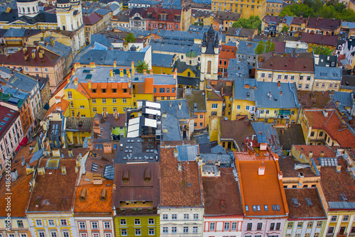 Rows of colorful and funny small houses, streets view of Lviv old town with traditional architecture, Ukraine. Cute buildings with saturated walls and roof who filled with history and life in city. 