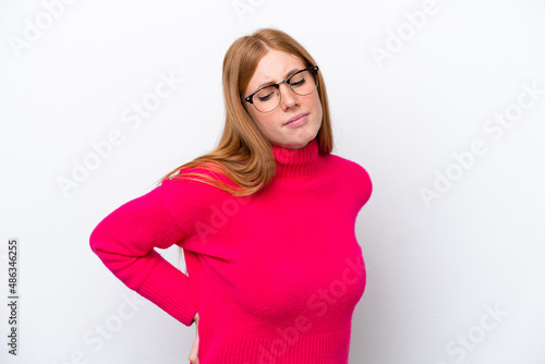 Young redhead woman isolated on white background suffering from backache for having made an effort