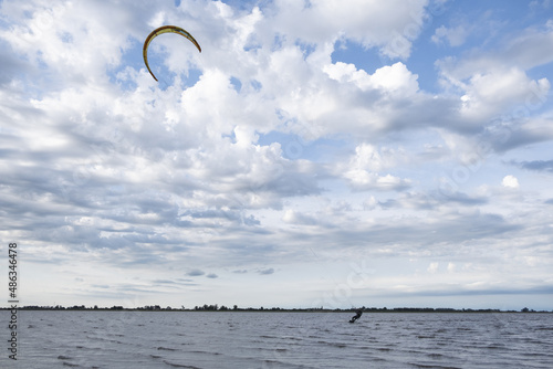 Beautiful shot of kitesurfing under the cloudy skies