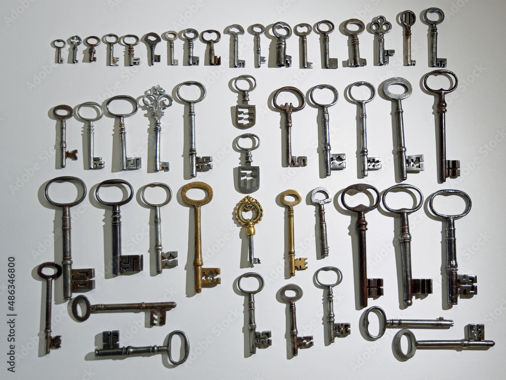A Collection of 48 Antique Keys on white background A Collection of 48 Antique Keys on white background