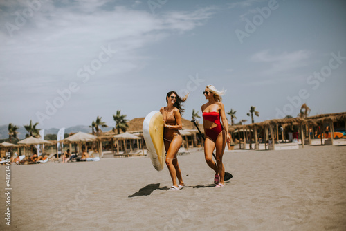 Two young women with paddle...