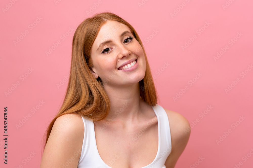 Young redhead woman isolated on pink background Young redhead woman isolated on pink background