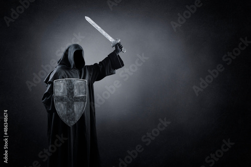 Dark knight with sword and shield in the dark photo