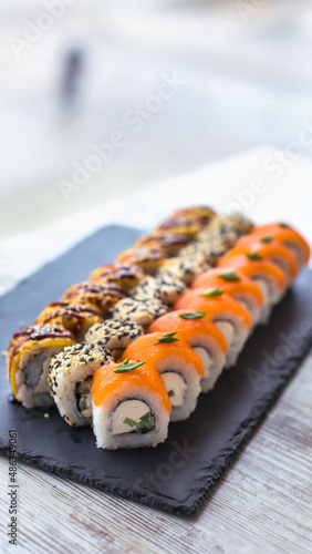 Sushi Set nigiri and sushi rolls on black stone slate plate board