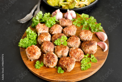 Fried meatballs on cutting board