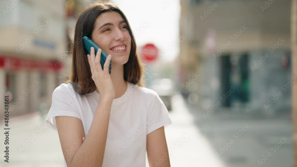 Young hispanic girl smiling confident talking on the smartphone at street Young hispanic girl smiling confident talking on the smartphone at street