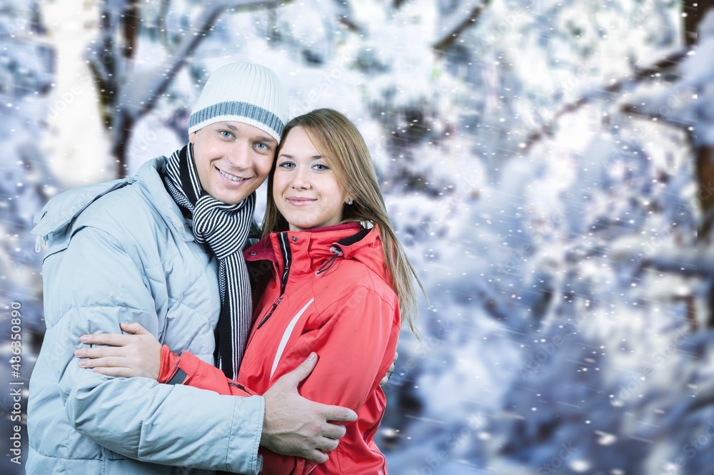 Fototapeta premium Photo portrait of cheerful couple walking together hugging in snowy dating