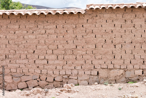 Wall of a house made entirely with mud bricks in Maras, Sacred Valley, Peru photo