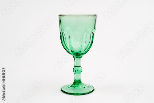 Isolated green wine glass champagne glass. Gray background.