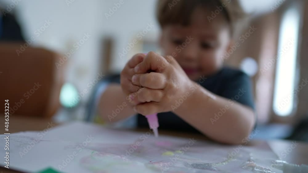 Child plays at home with arts and crafts pressing paint Child plays at home with arts and crafts pressing paint