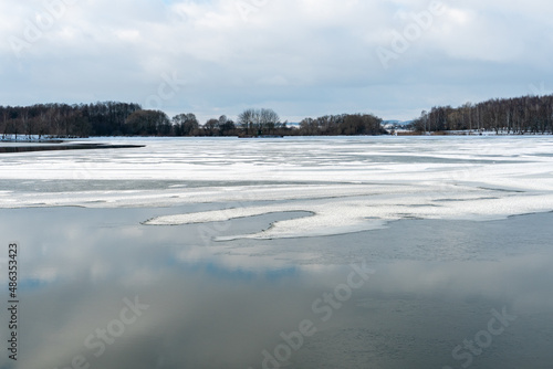 Wallpaper Mural Beautiful winter landscape forest on the lake shore on a sunny frosty day. Panorama of the coastline covered with snow and birch grove. Ice on the river and the reflection of clouds in the water. Torontodigital.ca