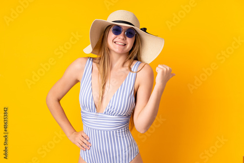 Teenager Ukrainian girl in swimsuit and pointing side