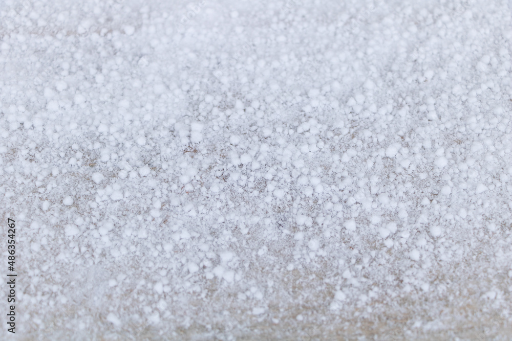 A closeup shot of snow in a form of small balls texture