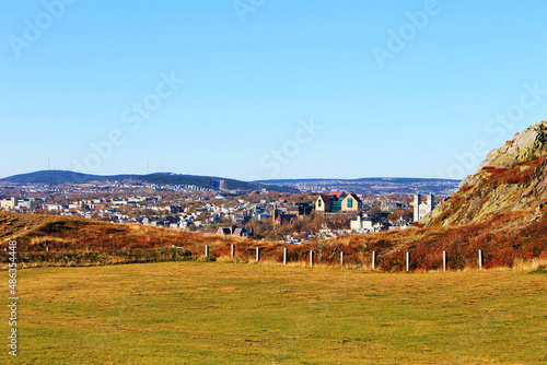 View of St. John's, NL, looking across a field on Signal Hill toward the city, autumn.
