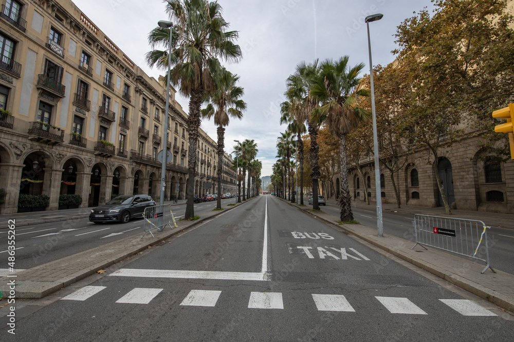 Barcelona, Spain - November 20, 2021: Early morning in Barcelona. There are few people and vehicles on the street. Empty city