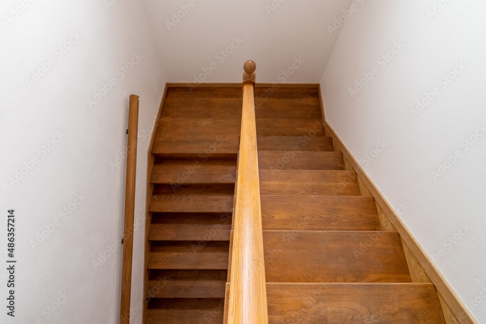 Foto de Contemporary wood stairway. Interior wooden stairs. Staircase going down. Pathway of