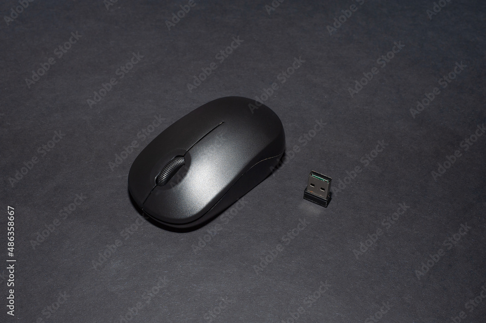 Computer mouse. The computer mouse on a black background. Concept of using computer items, remote work, homeoffice Computer mouse. The computer mouse on a black background. Concept of using computer items, remote work, homeoffice