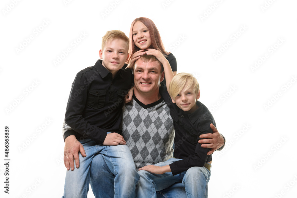 Half-length portrait of a father and three children in casual clothes on a white background Half-length portrait of a father and three children in casual clothes on a white background