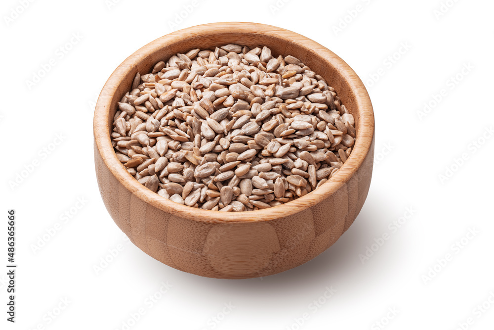 Raw sunflower seeds in wooden bowl isolated on white background Raw sunflower seeds in wooden bowl isolated on white background