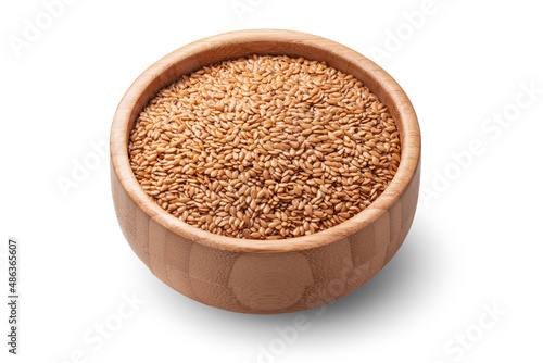 Golden flax seed or linseed in wooden bowl isolated on white background.