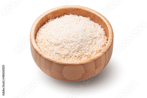 Coconut flakes in wooden bowl isolated on white background
