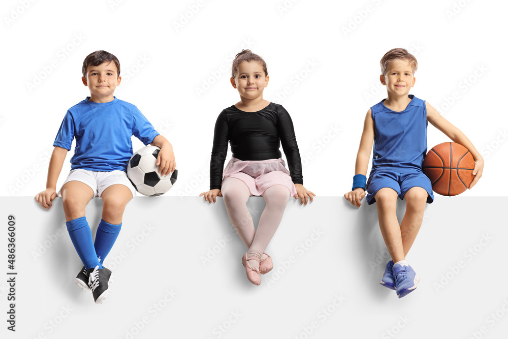 Naklejka premium Ballerina girl, boys with football and basketball sitting on a blank panel