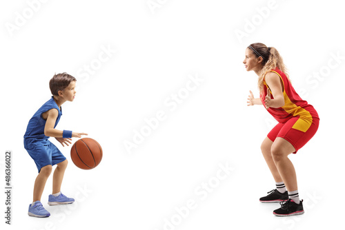 Full length profile shot of a female basketball coach and a little boy playing basketball © Ljupco Smokovski