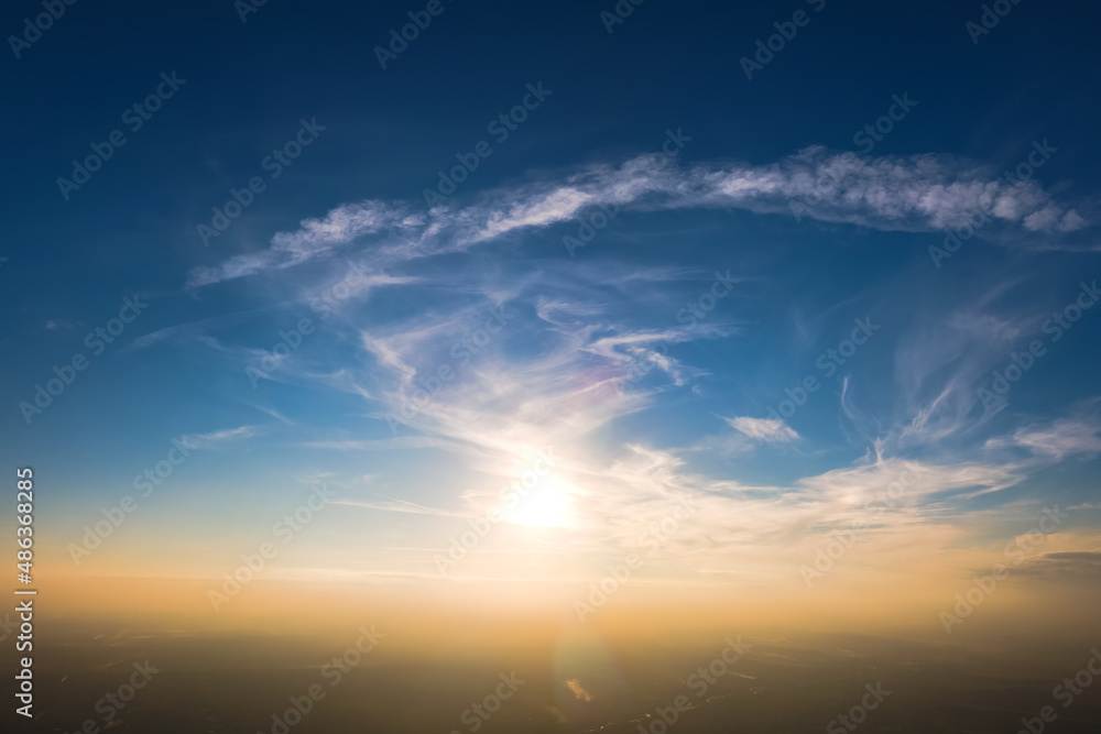 Bright colorful sunset sky with setting sun and vivid soft clouds. Concept of nature and environment