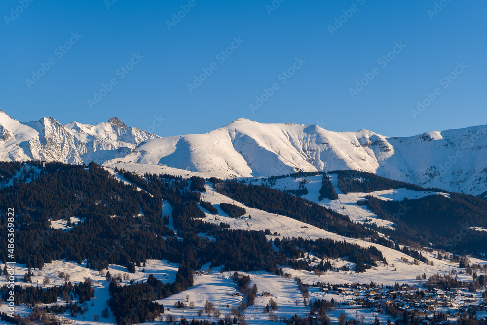 The mountains above the city of Megeve in the middle of the Mont Blanc massif in Europe, France, Rhone Alpes, Savoie, Alps, in winter, on a sunny day.