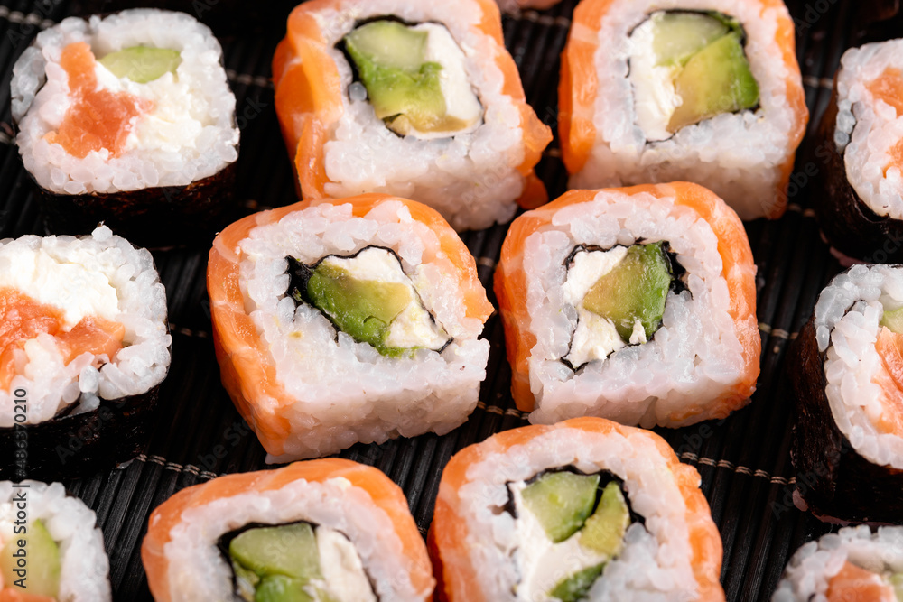 Sushi Rolls Philadelphia with salmon, avocado, soft cheese Sushi Rolls Philadelphia with salmon, avocado, soft cheese
