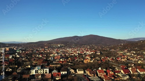 The Mukachevo city at the evening with beautiful mountains panorama aerial view photo