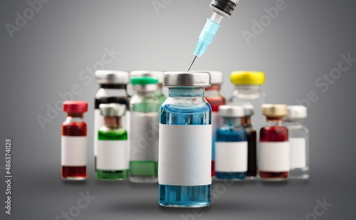 COVID-19 Vaccine vials, Original vaccine vials with a syringe on blurred background
