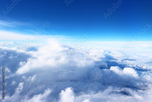Clouds photographed from the plane, high attitude, blue 
