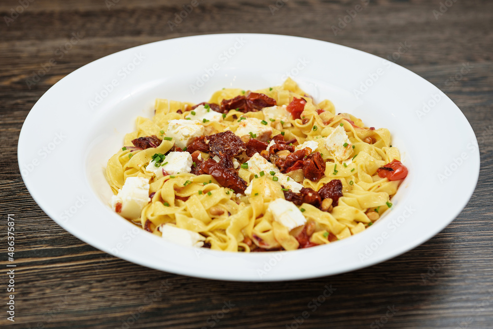 Hot dishes with pasta, cheese, vegetables and meat