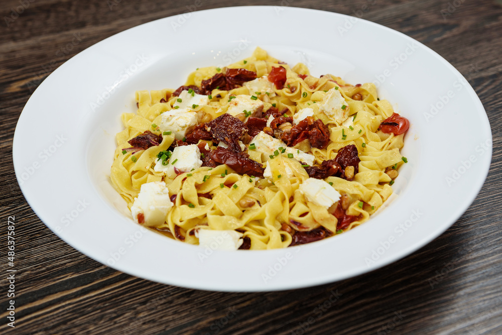 Hot dishes with pasta, cheese, vegetables and meat