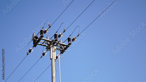 tower of electrical cables against sky