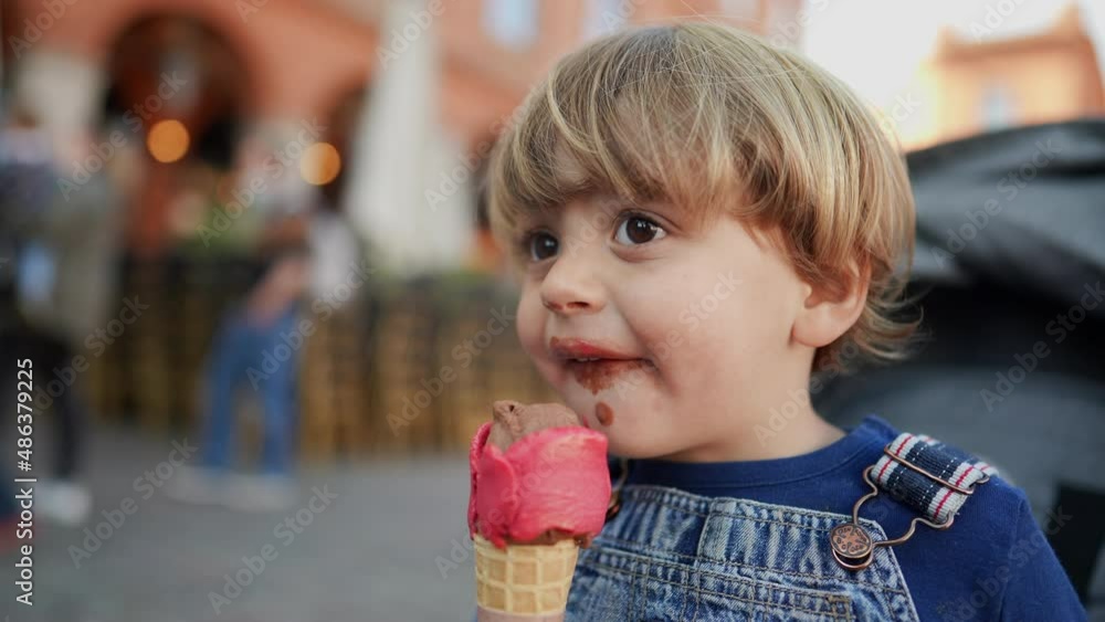 Little boy eating icecream child eats desert Little boy eating icecream child eats desert
