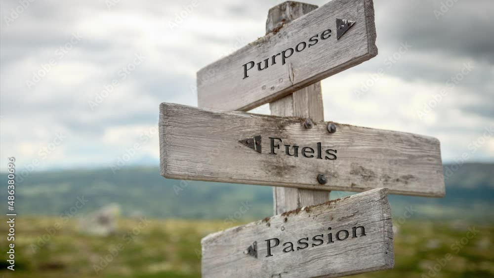 purpose fuels passion text engraved on old wooden signpost outdoors in ...